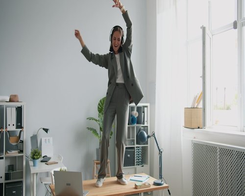 Indian professional doing light stretching near office desk